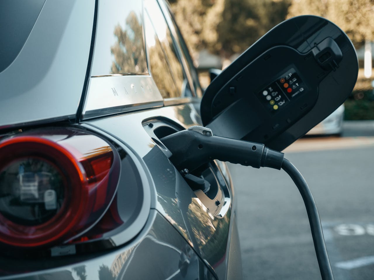 about-us Close-up of an electric vehicle being charged, highlighting modern clean energy technology.